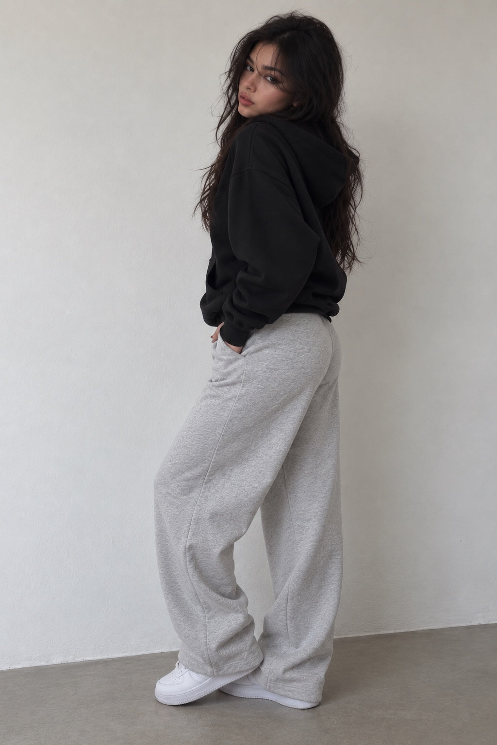 Model wearing Grey Sweats light grey sweatpants with black hoodie